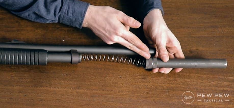 Spring goes into the magazine tube and then tighten down your magazine cap.