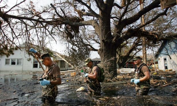 National Guardsmen Scour a neighborhood during hurricane Katrina