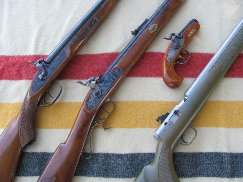 Left to Right: Reproduction muzzleloading shotgun, Thompson/Center 50 caliber Hawken, 45 caliber Philadelphia Derringer (I made this from a kit in 7th grade woodshop! My, how times have changed), Thompson/Center Black Diamond 50 Caliber inline