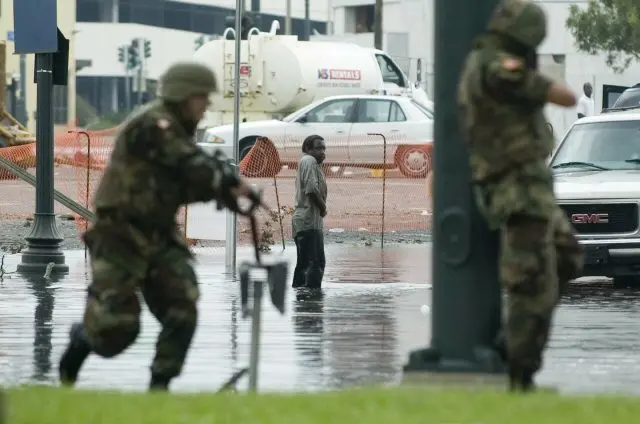 National Guardsmen take aim at a suspected armed man in the wake of Hurricane Katrina