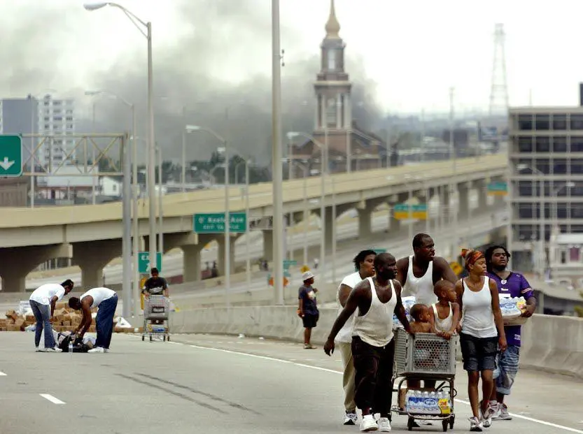 Families use the highways as pedestrian routes during Hurricane Katrina