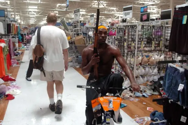 Strapped with what's likely a BB gun inside a retail store in the aftermath of Hurricane Katrina