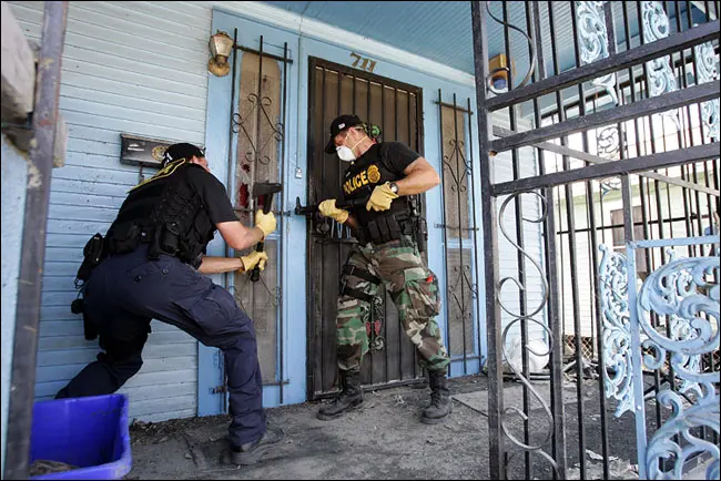 LEOs make entry on a home during Katrina's mandatory evacuation enforcement