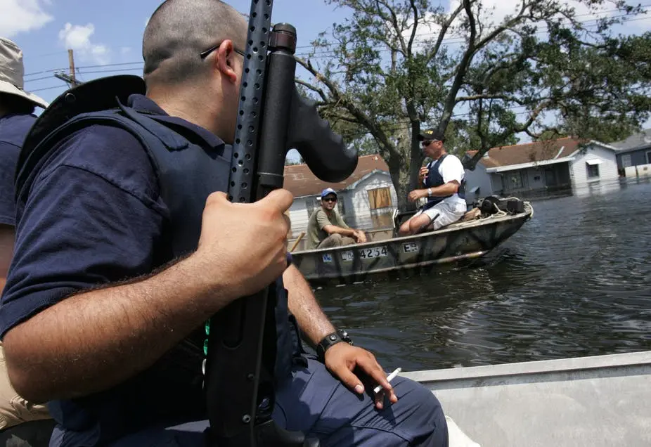 Police patrol the waterways by boat during the aftermath of Katrina