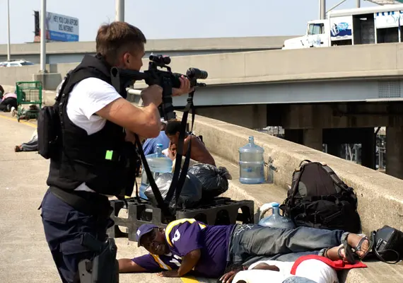 Police take aim at suspected looters on an overpass during Katrina