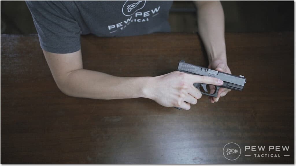 Handgun Three Grip with Index Finger Along Slide