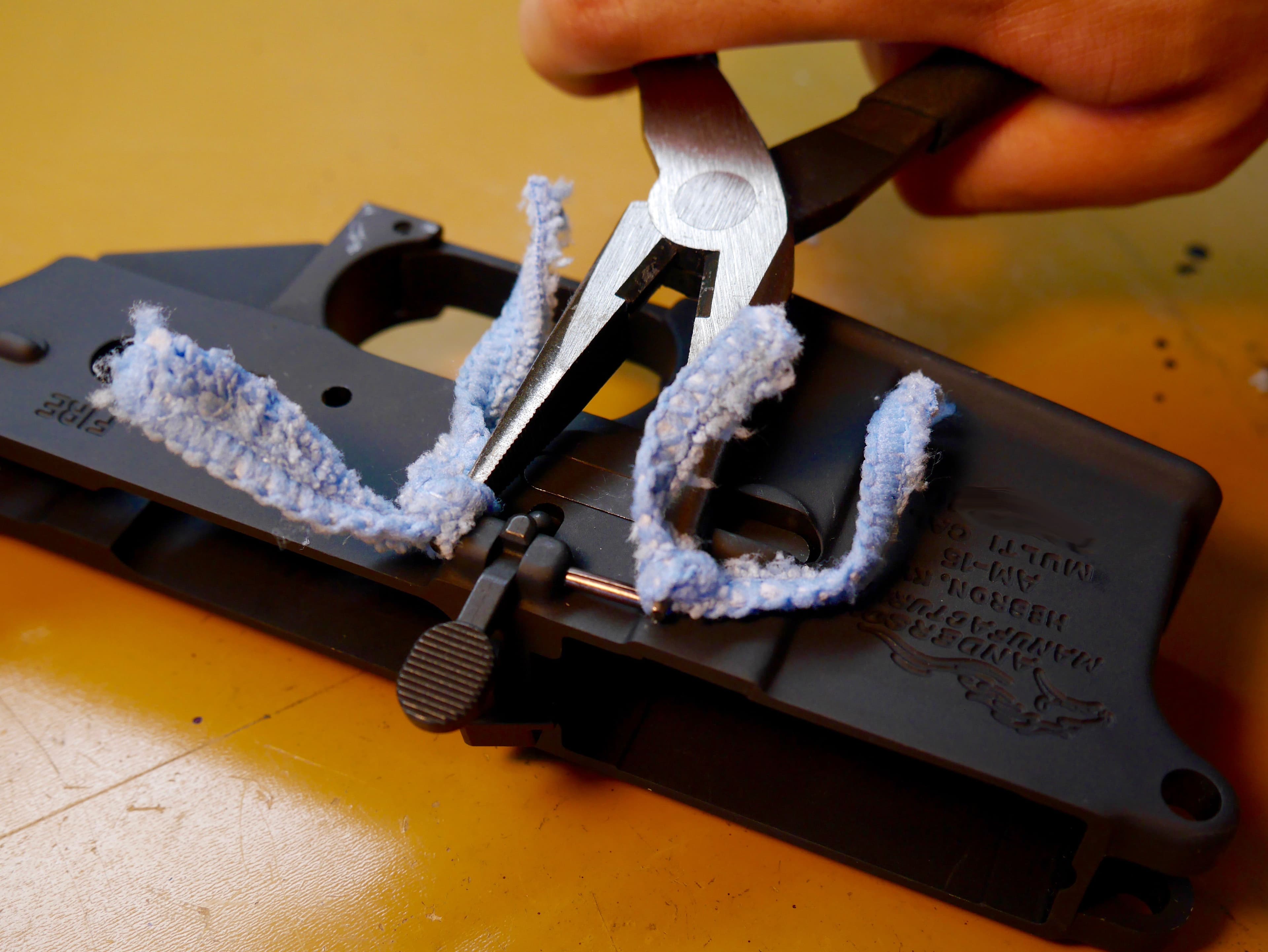 Squeezing the Bolt Catch Pin