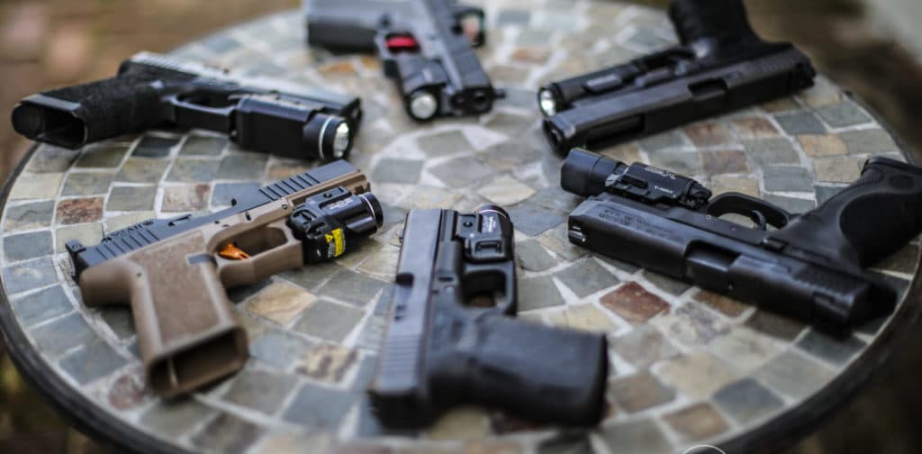 Circle of pistols on a table