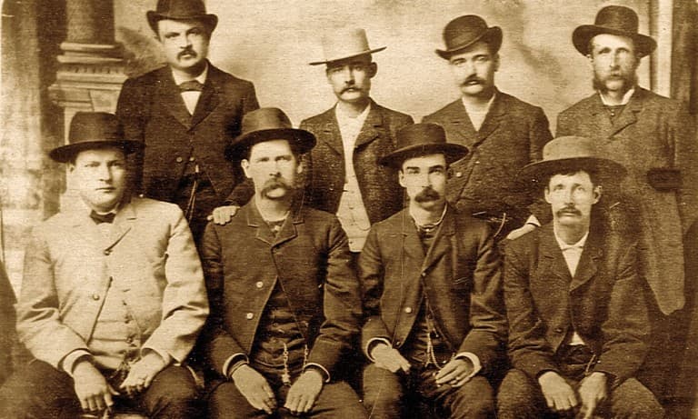 Bat Masterson (standing second from right), Wyatt Earp (sitting second from left), and other deputy marshals during the Wild West era
