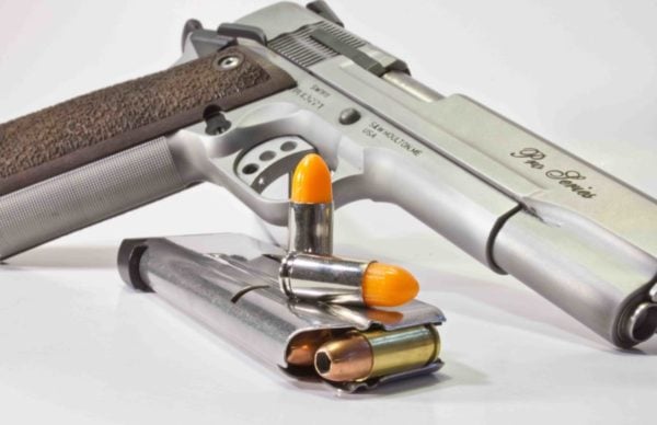 Pistol with Loaded Magazine and Two Dummy Bullets