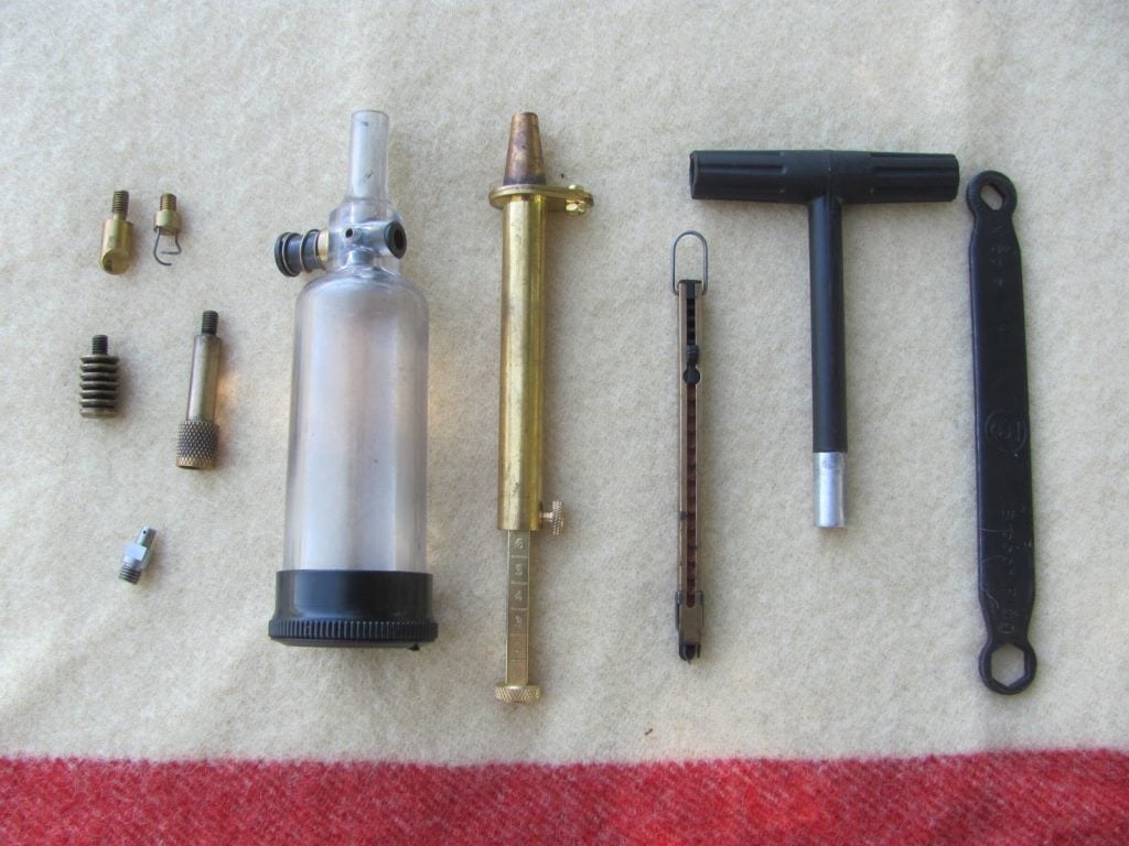 breech scraper, patch worm, 2 different patch jags, stainless nipple, powder flask, powder measure, inline capper, T-handle that is also a short-starter, breech and nipple wrench.