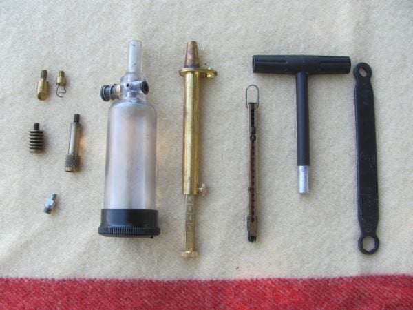 breech scraper, patch worm, 2 different patch jags, stainless nipple, powder flask, powder measure, inline capper, T-handle that is also a short-starter, breech and nipple wrench.