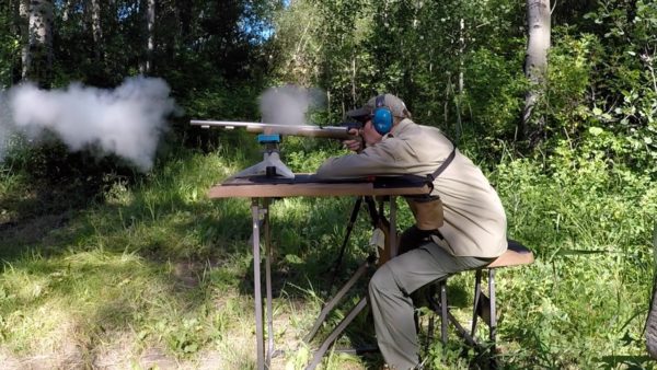 man shooting muzzleloading rifle