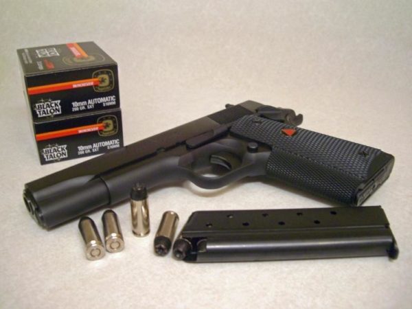 Colt-Delta-Elite-with-boxes-of-Black-Tal