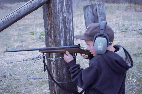 Boy shooting rifle