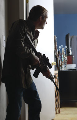 Man defending with rifle