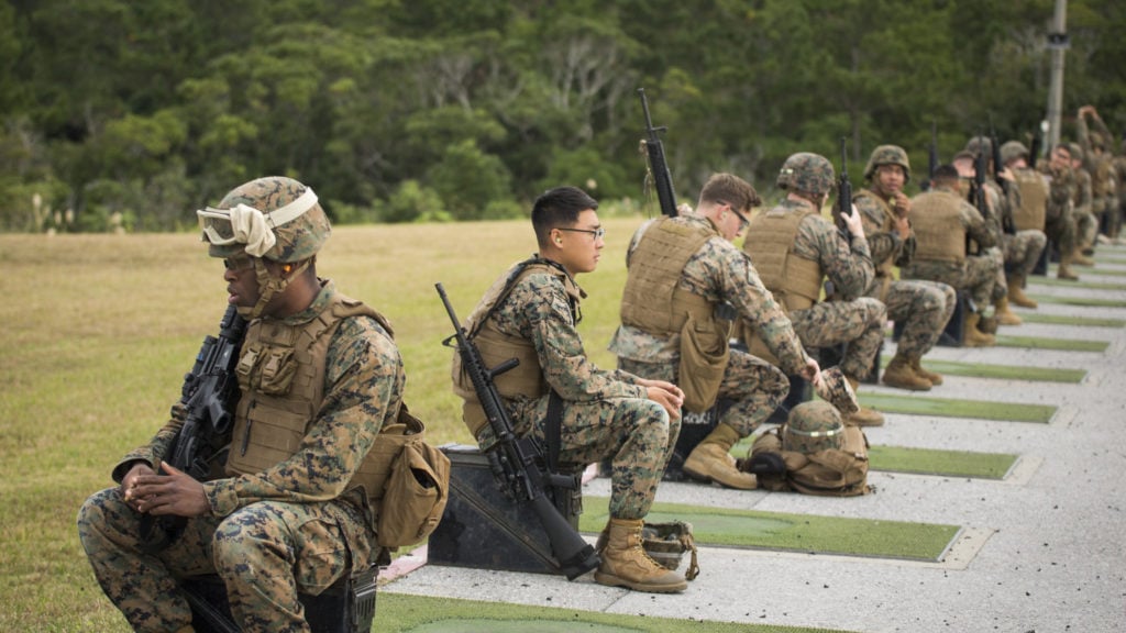 Marines from various units within Okinawa prepare for their turn to fire the table two portion of the annual rifle range qualification, Jan. 12, 2017, at Camp Hansen, Okinawa, Japan. The Marine Corps revised table two of the marksmanship program October 2016 to increase marksmanship skill and realism in a combat environment. The Corps requires Marines to annually qualify at the range to determine their marksmanship skill. (U.S. Marine Corps photo by Lance Cpl. Andy Martinez)