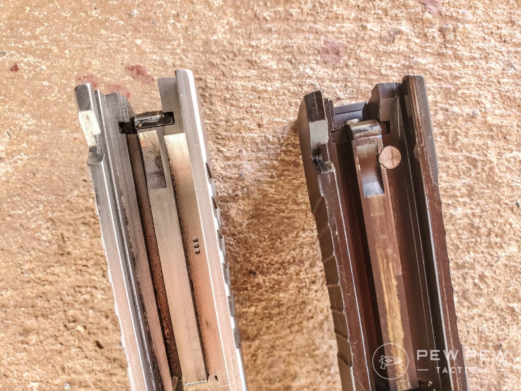 The Series 80 1911 at the top of the picture has a safety plunger in the slide, visible as a small circular metal piece near the back of the slide. The Series 70 1911 under it does not