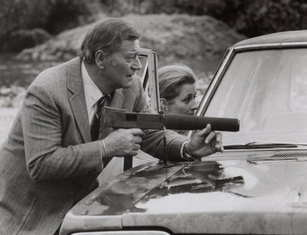 John Wayne and his MAC-10 in ‘McQ.’ Warner Bros. capture