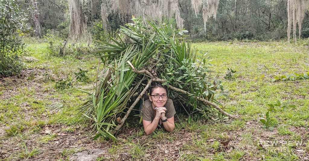 Bushcrafting Completed Shelter with person