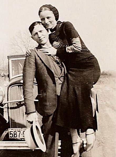 Bonnie and Clyde in front of their car