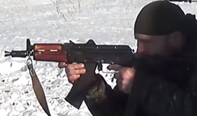 Fighter of the LPR 1st Separate Mechanized Battalion "August" firing his AKS-74U