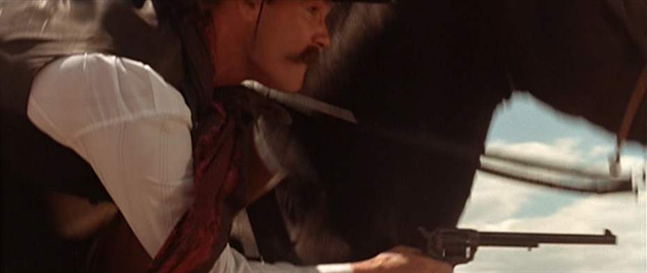 Kurt Russell's Wyatt Earp fires the Buntline while riding against the Cowboys