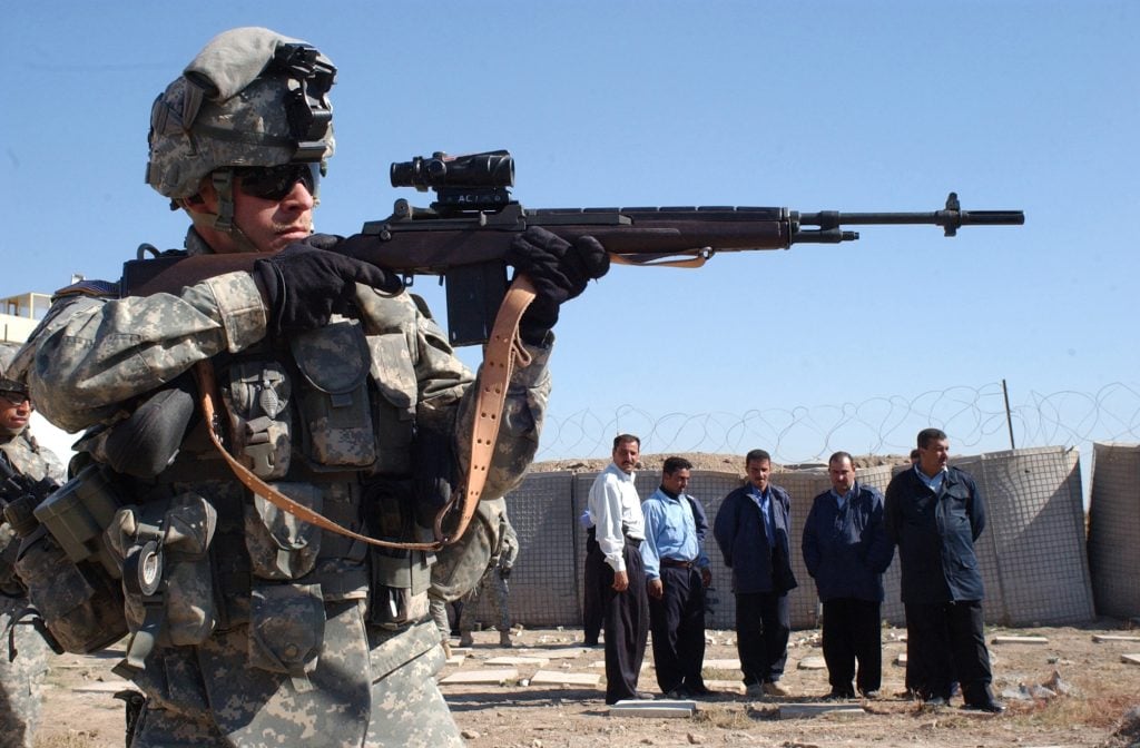 U.S. Army Sgt. 1st Class Richard Wiley demonstrates shooting an M-14 rifle to Iraqi Highway Patrol (IHP) police officers during close-quarters marksmanship Nov. 17, 2006, at the Al Samud IHP Station in Iraq. Wiley is a platoon sergeant with Alpha Company, 3rd Battalion, 509th Infantry Regiment, Fort Richardson, Alaska. (U.S. Army photo by Spc. Olanrewaju Akinwunmi) (Released)