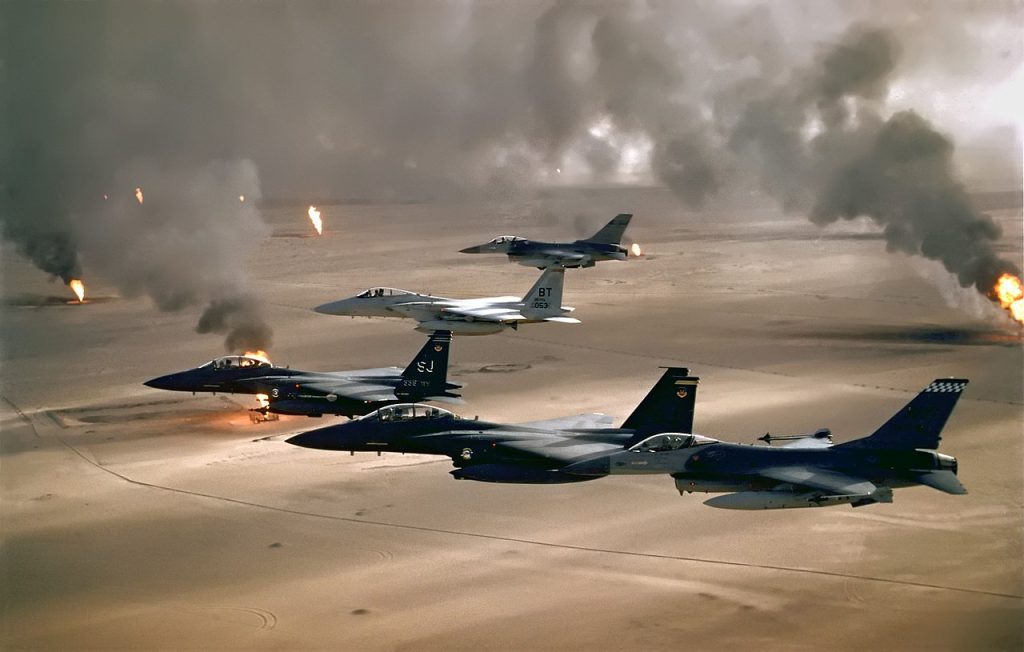 USAF aircraft of the 4th Fighter Wing (F-16, F-15C and F-15E) fly over Kuwaiti oil fires during Operation Desert Storm